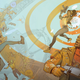 Key art for Deathloop showing Colt and Julianna against a '60s-inspired background